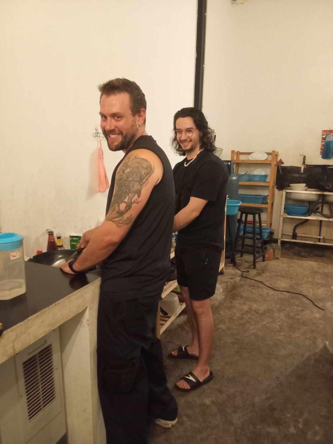 Two volunteers smiling at the Aurora kitchen counter — Aurora, a top restaurant in Pai (healthy Pai restaurant, health-focused)