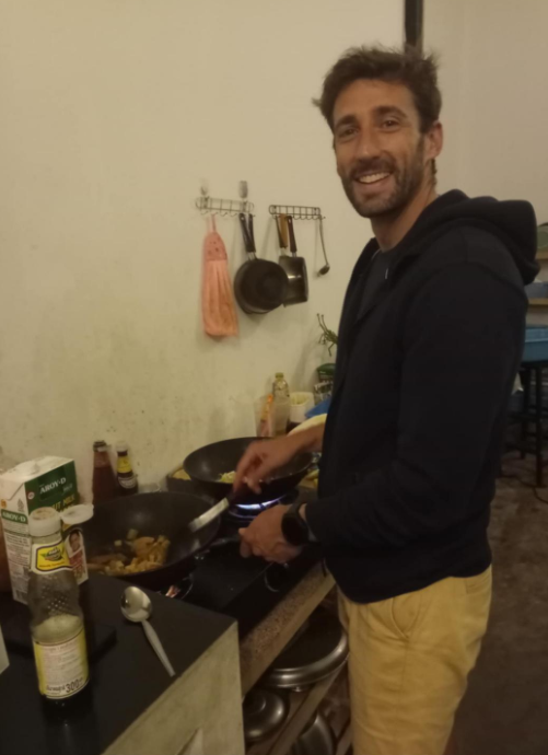 Volunteer stir-frying at the wok station — Aurora, a top restaurant in Pai (healthy Pai restaurant, health-focused)